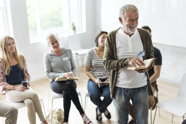a man reading in front of a support group