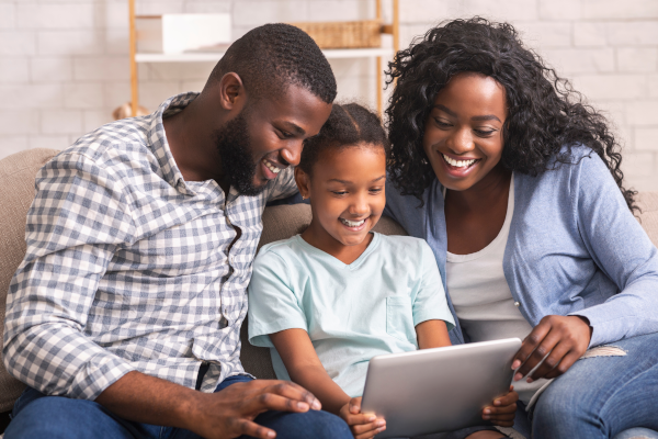 a family reading together on an ipad